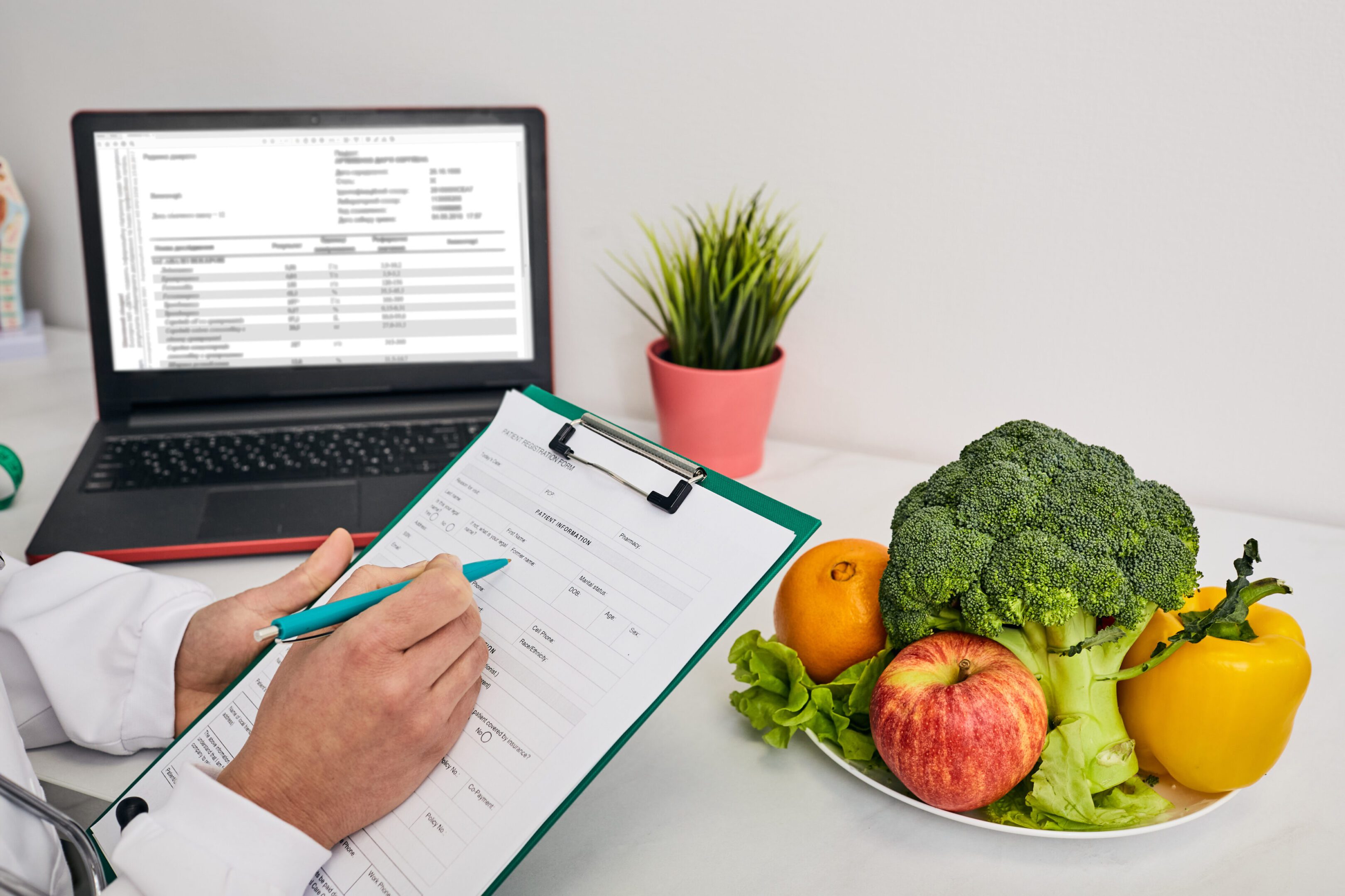 Nutritionist writing notes near fresh vegetables.